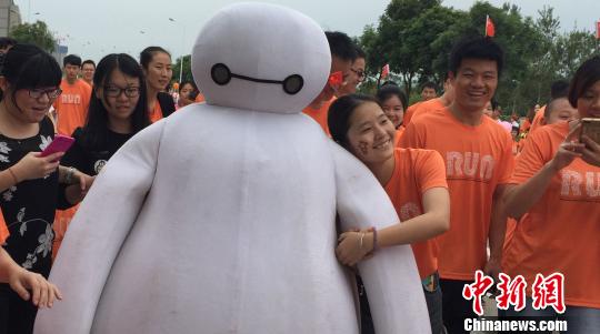 11日早晨8時40分許,隨著一聲發令槍響,1800位兩岸民眾在廈門海滄長庚醫院內一起出發,開跑賽程4公里的“永慶杯”路跑。圖為路跑中的“大白”吉祥物受到路跑選手熱捧。 陳悅 攝